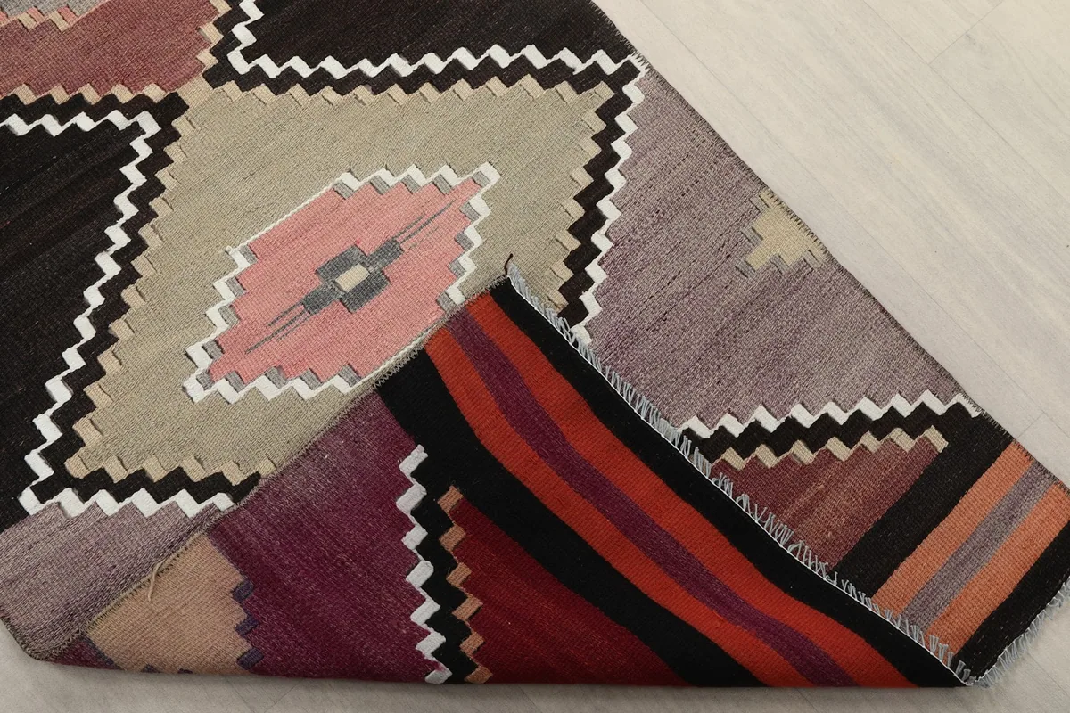 Underside of the hand-knotted rug, showing the cotton foundation and tight weave