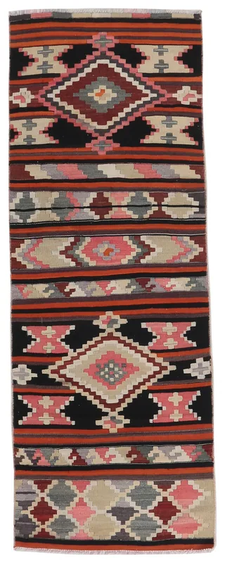 Full top view of the vintage Anatolian runner with black, orange, pink, and beige geometric patterns