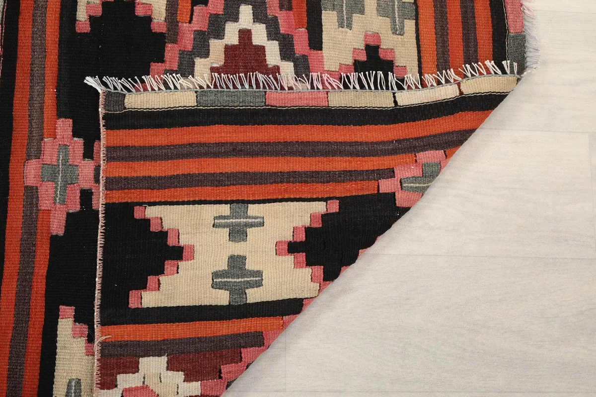 View of the back of the rug, revealing the tightly woven cotton foundation and wool knots