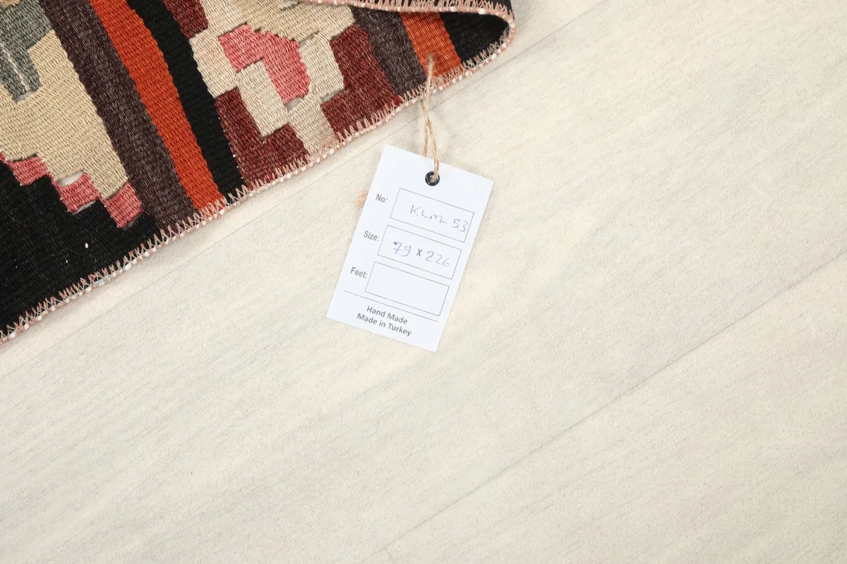 Rug tag displaying origin as Anatolia, Turkey, and hand-knotted wool material details