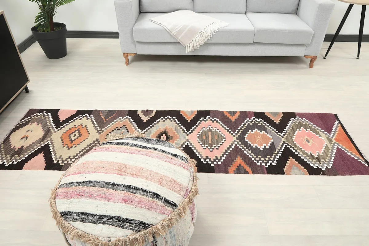 Long view of the Anatolian runner rug extending through a room, showing its full length