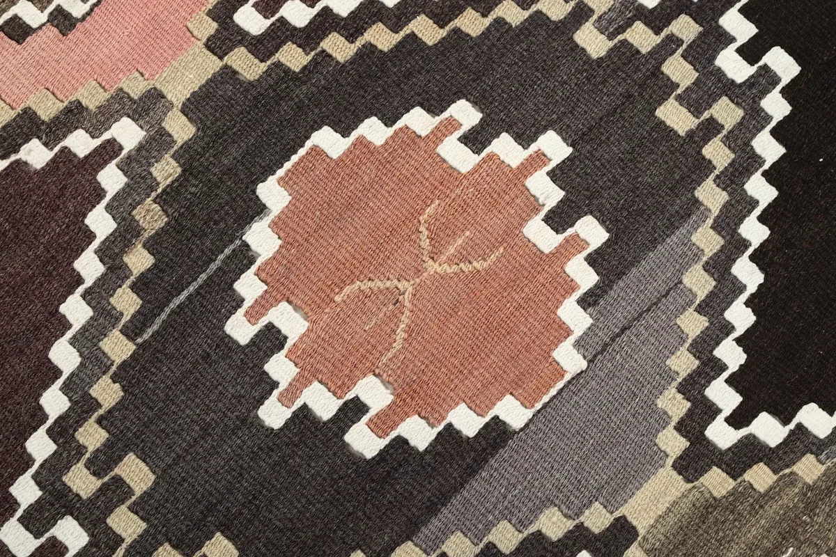 Intricate detail of a rust-colored geometric motif with subtle internal patterns