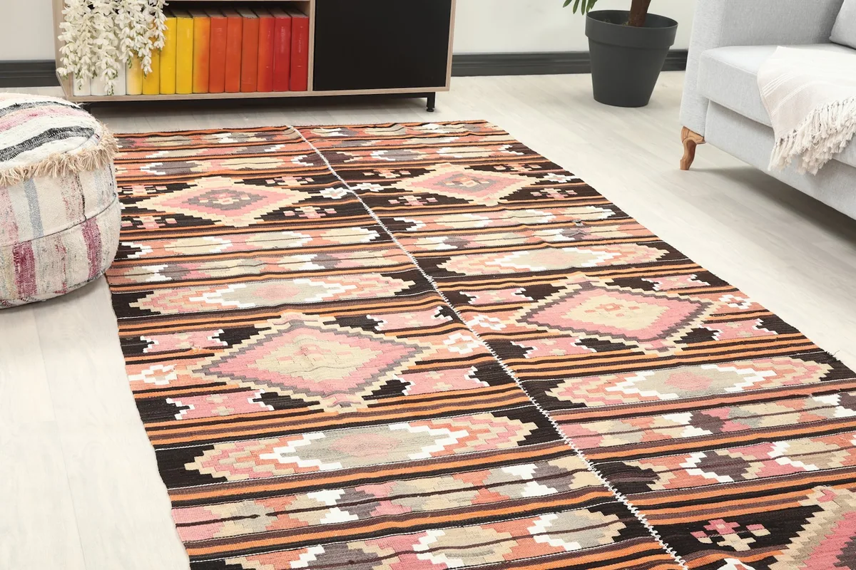 Close-up angled view of the rug's pattern and colors within a room setting