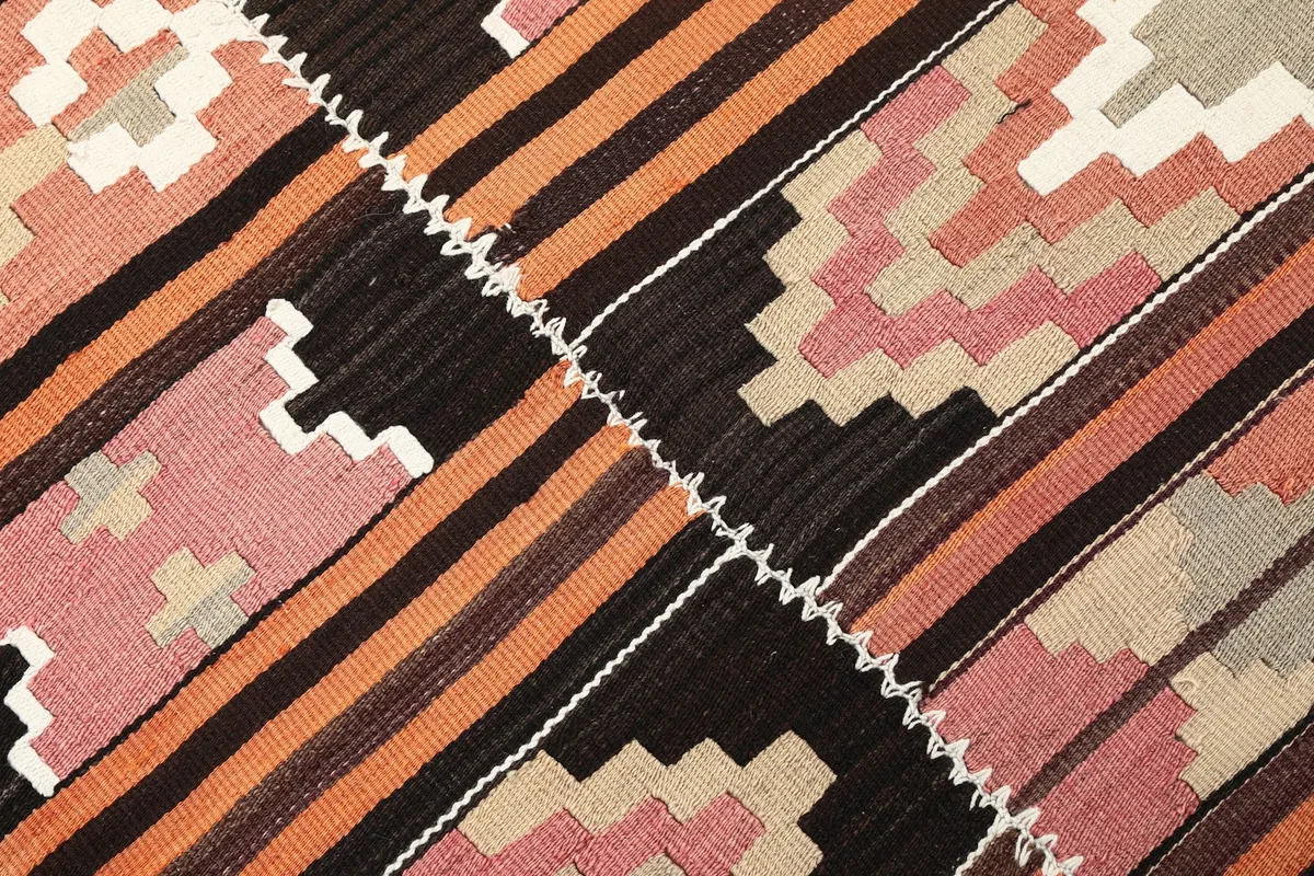 Close-up of the central seam and various geometric shapes in the rug
