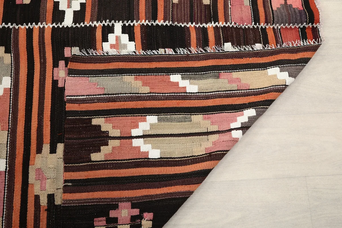 Underside view of the rug, showing the hand-knotted cotton foundation and fringe