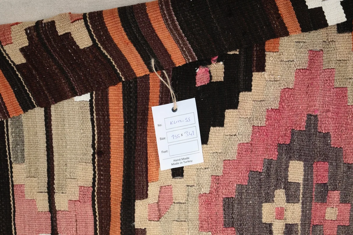 Close-up of the rug's texture with a product tag attached, showing details of the weave