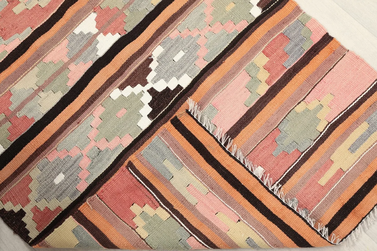 The rug folded to reveal its thickness and the reverse side of the hand-knotted weave
