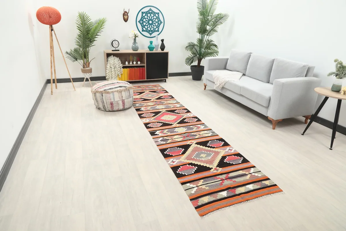 Angled view of the runner rug in a room setting, highlighting its colors and how it fits the space.