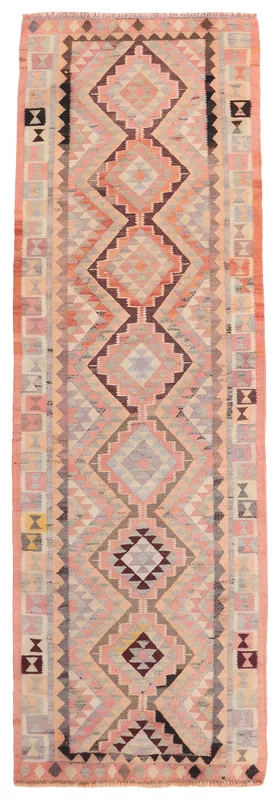 Full overhead view of the rose and gray geometric Anatolian runner on a white background