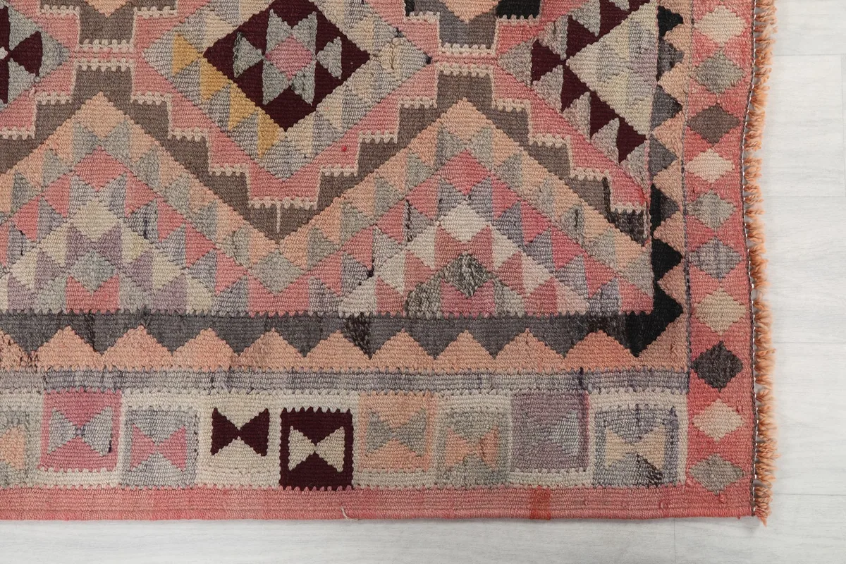Detailed view of the runner's end, showing small geometric motifs and border design