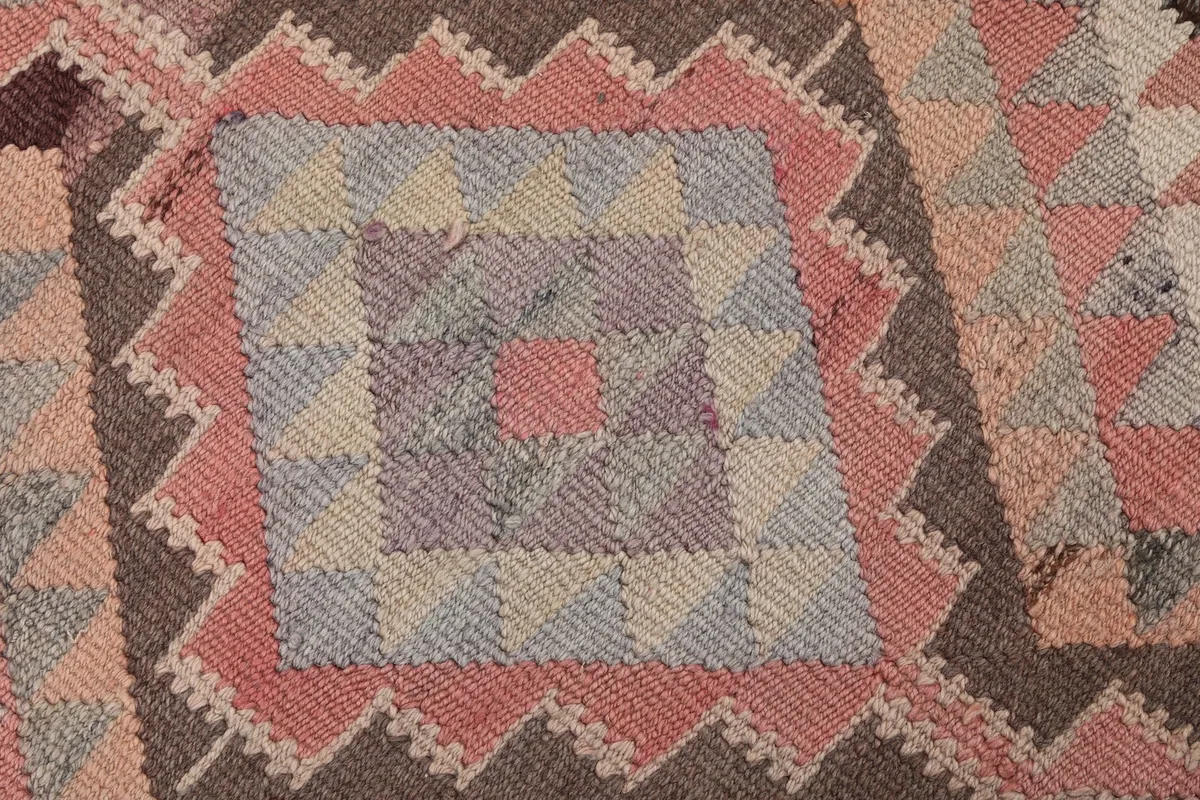 Macro detail of a single large diamond motif, highlighting the weave and color variations