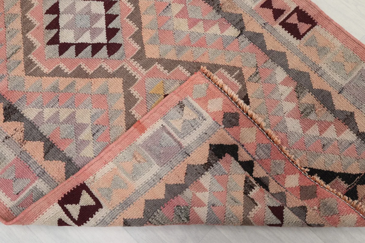 Folded corner of the runner, revealing the wool pile texture and hand-knotted construction