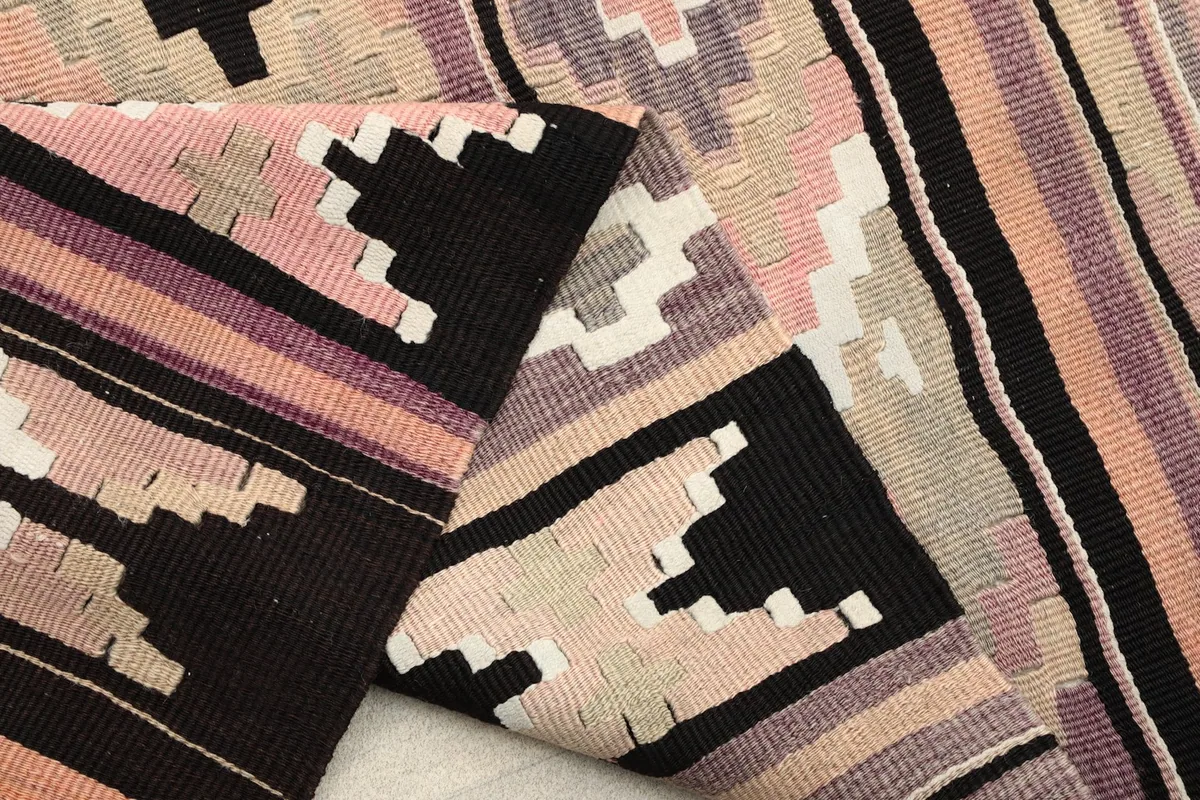 Folded section of the rug revealing the cotton foundation and reverse side of the knots