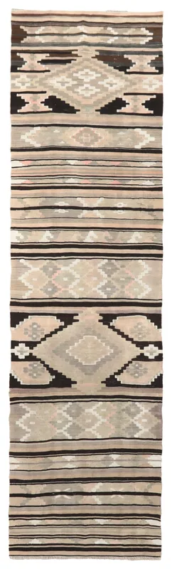 Full overhead view of the beige and black geometric vintage runner on a white background