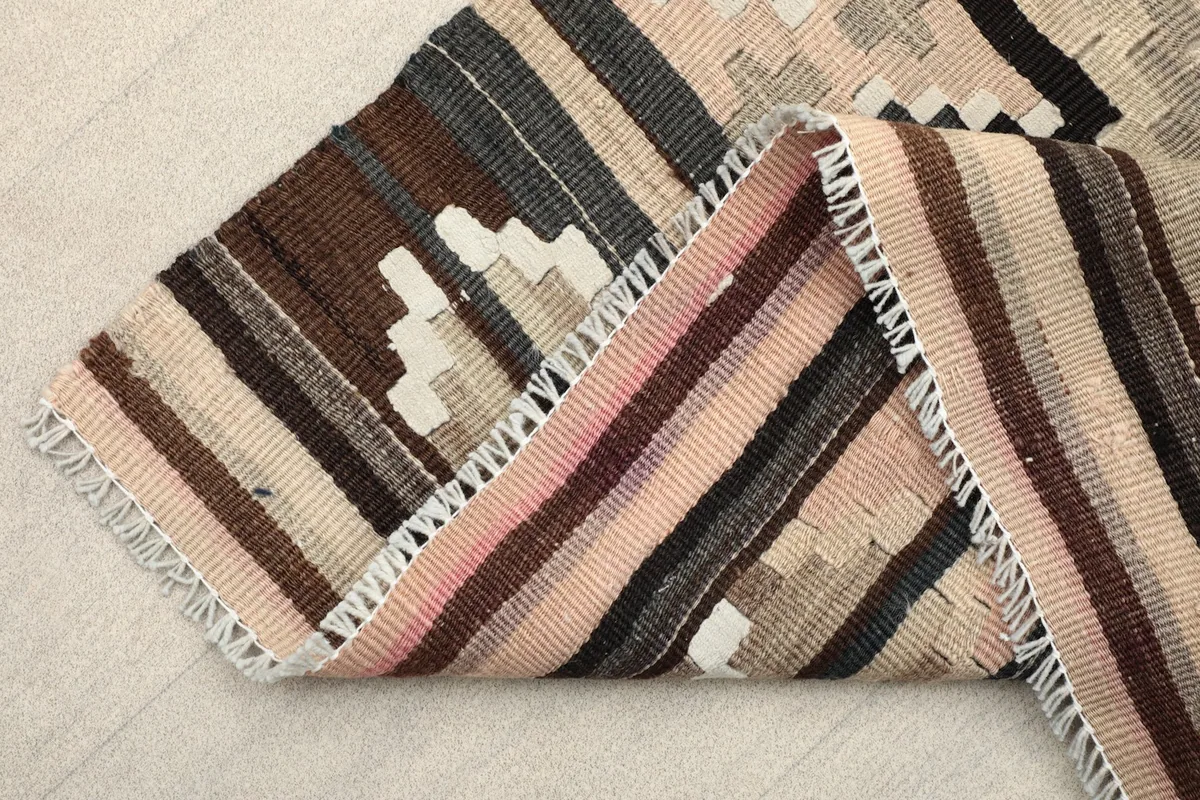 Folded corner of the runner showing the dense wool pile and fringe detail