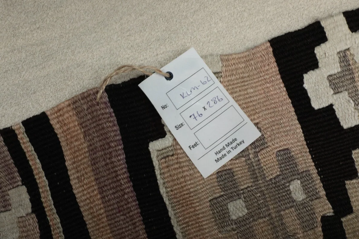 Close-up of the product tag attached to the rug, showing size and origin