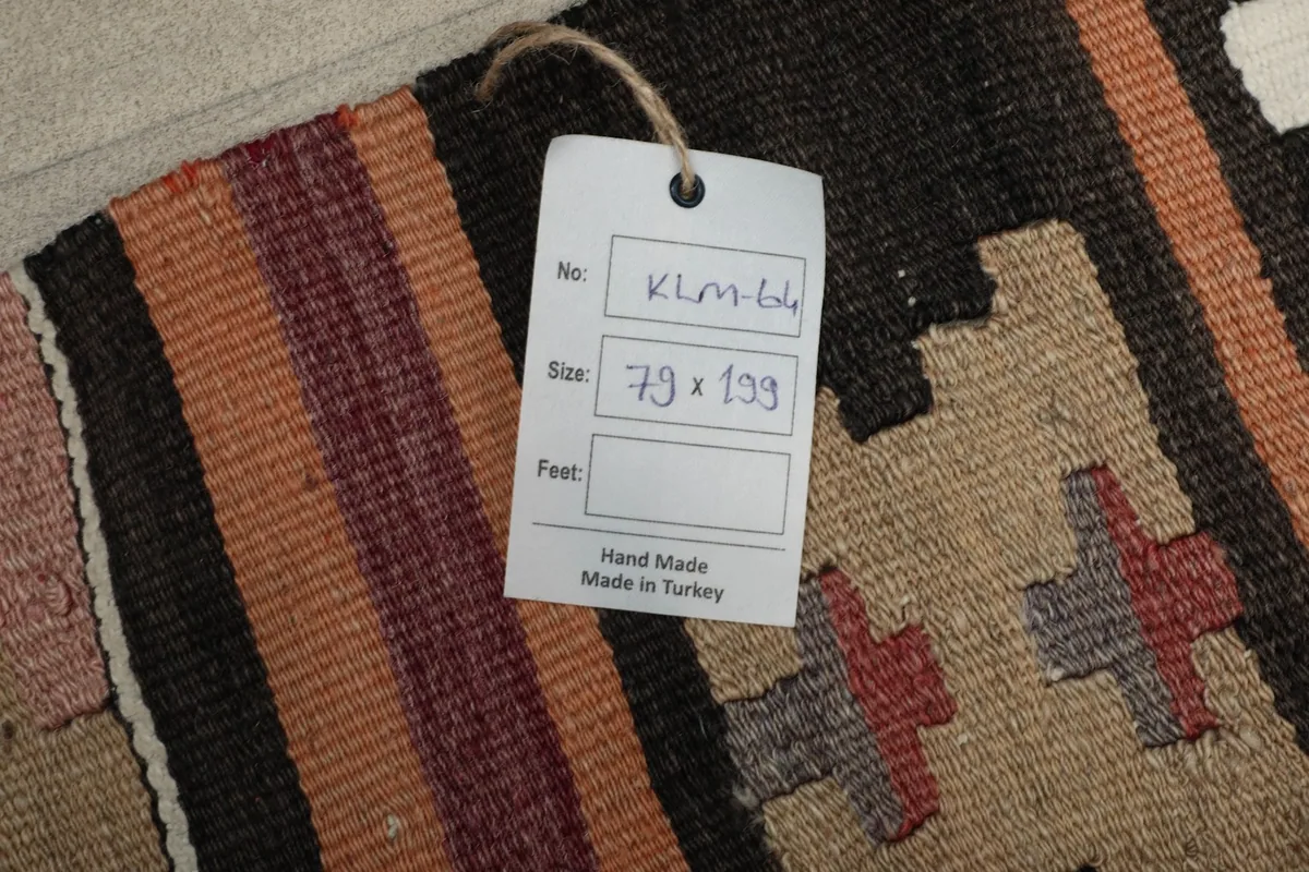 Close-up of the product tag indicating handmade in Turkey and the rug's dimensions