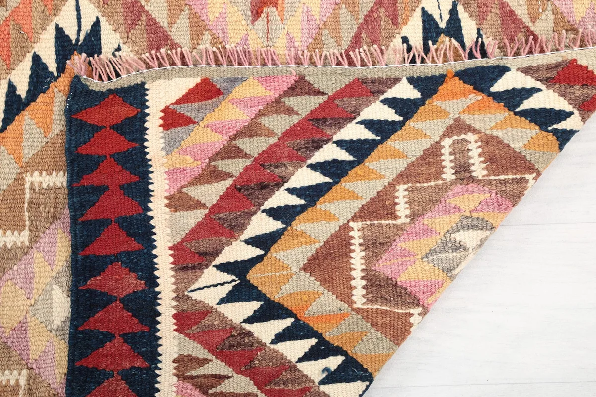 Folded section of the runner rug, revealing the thickness and texture of the wool pile