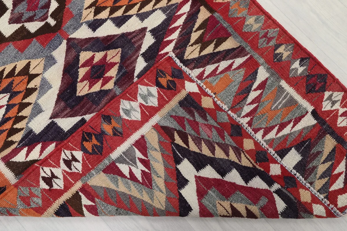 Folded corner of the runner revealing the dense hand-knotted wool pile and cotton foundation