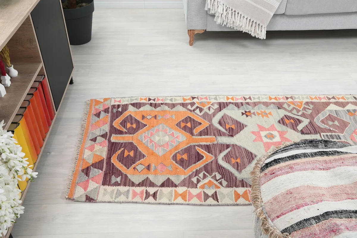 Angled overhead shot of the runner rug, emphasizing its position relative to the sofa and other room elements.
