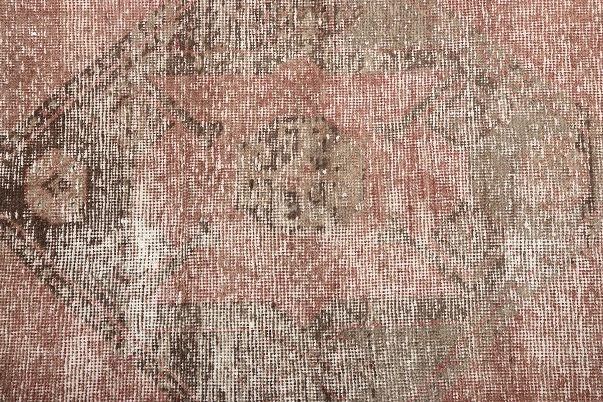 Macro view of the low wool pile and the intricate hand-knotted texture of the rug