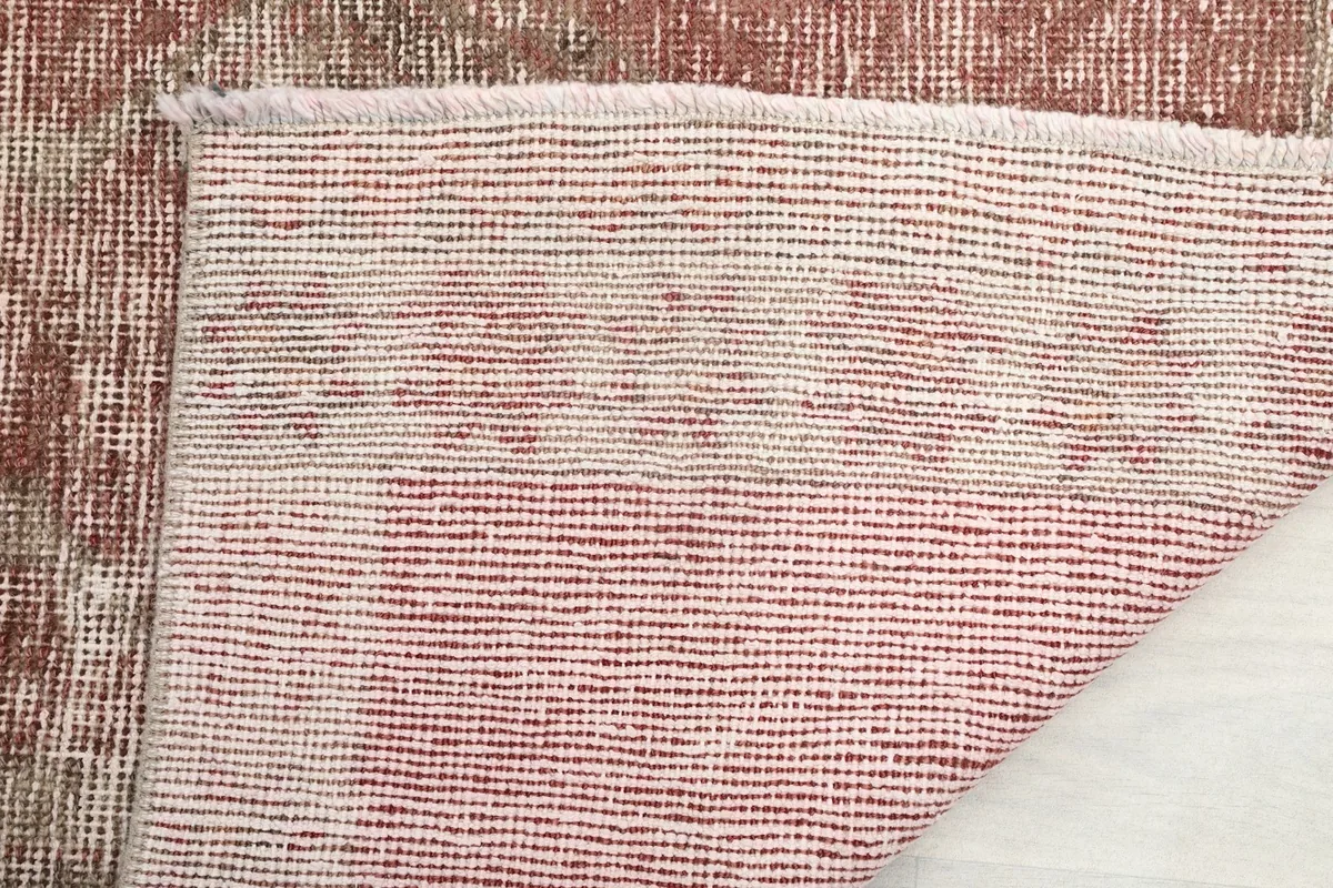 Underside view of the rug, showing the cotton foundation and hand-knotted construction