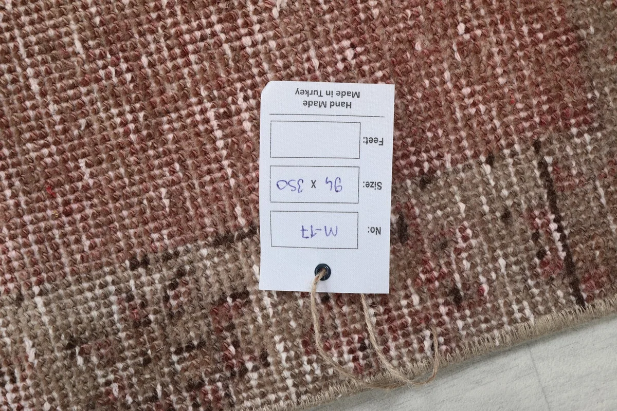 Product tag on the back of the rug displaying size in cm and country of origin
