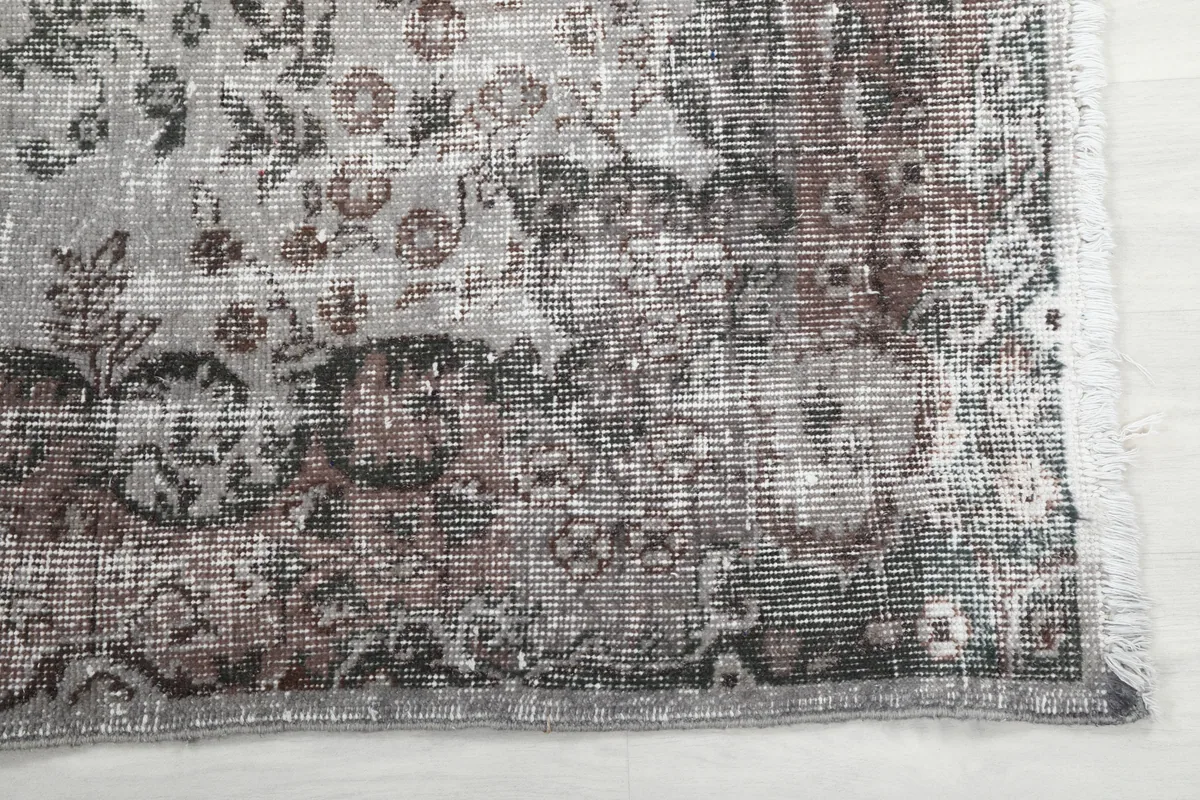 Detailed view of the Rose Gray Medallion Rug's faded rose and gray patterns