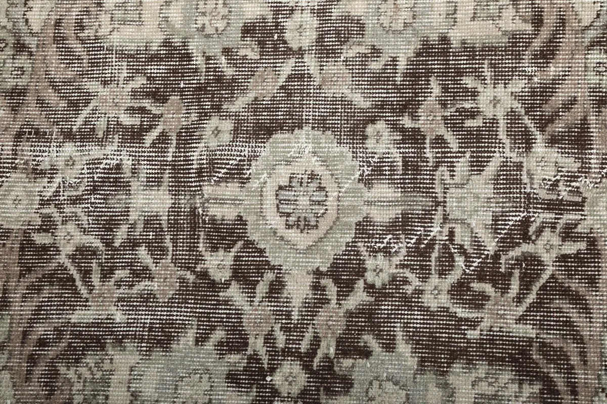 Close-up on the intricate floral and geometric motifs within the rug