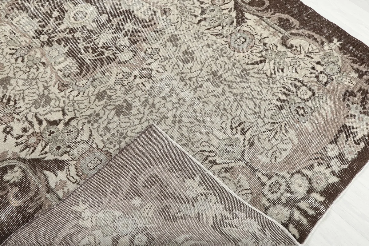 Folded corner of the rug, revealing the wool pile and cotton foundation