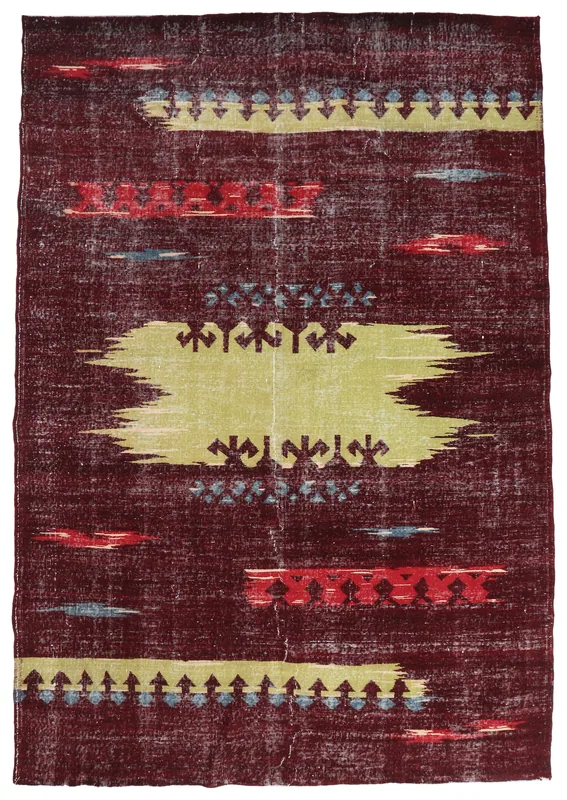 Full top view of the vintage Anatolian rug with a red field and abstract yellow and blue motifs