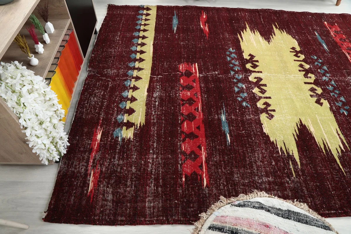 Diagonal view of the rug, capturing the interplay of red, yellow, and blue colors
