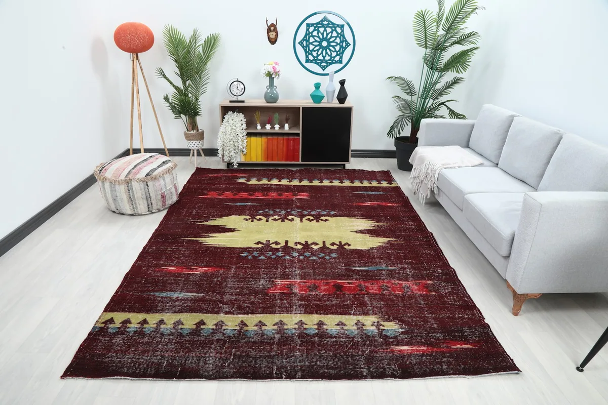 Vintage Anatolian rug displayed in a modern living room setting, showing its scale and colors