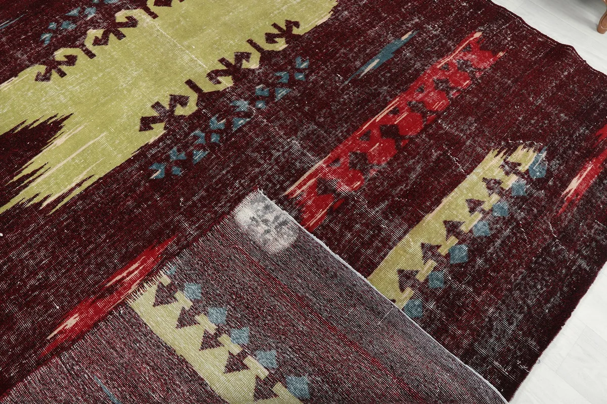 Showing a corner of the rug flipped to reveal the hand-knotted cotton foundation