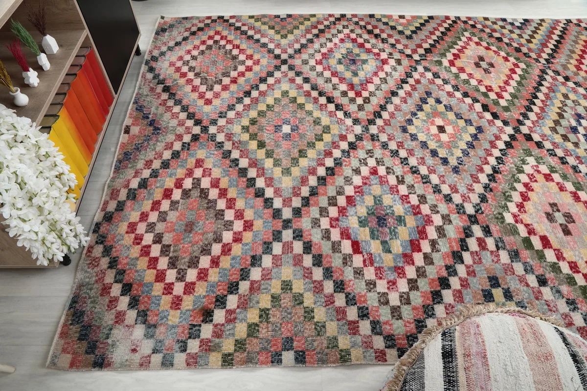 Corner view of the hand-knotted multicolor rug, showing its placement in a room setting.