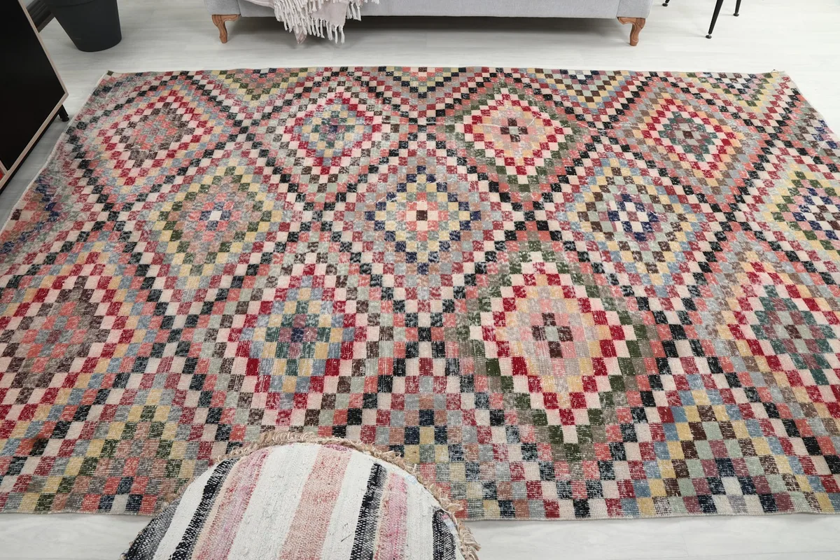 Full view of the multicolor geometric rug on the floor, showcasing its size and impact in a room.