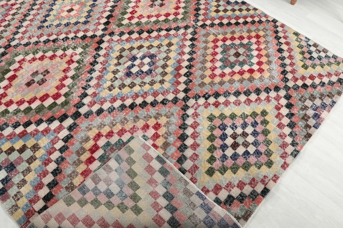 View of the back of the hand-knotted wool rug, revealing the cotton foundation and knotting detail.
