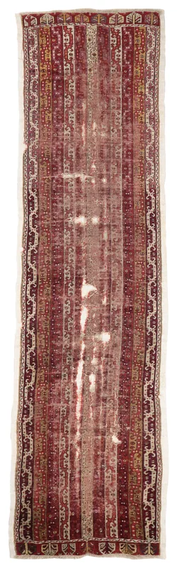 Full top view of the 3'3" x 13'3" red striped vintage Anatolian runner rug on a white background.