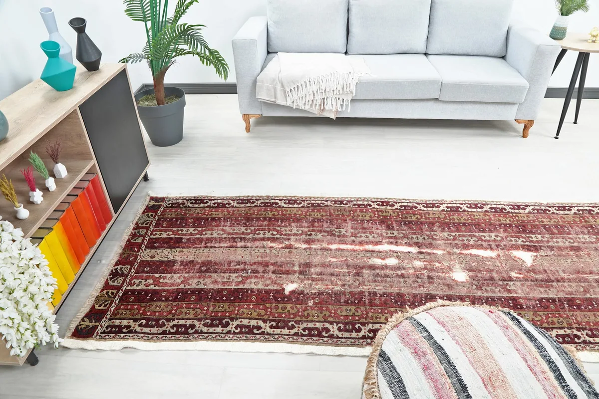Another room view of the runner rug, extending through a hallway area with furniture.