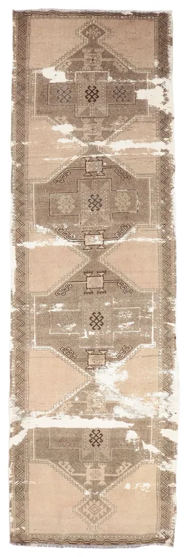 Full overhead view of the beige and brown distressed vintage runner rug