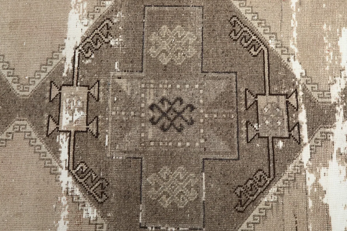 Central geometric medallion design with visible distressing on the vintage runner
