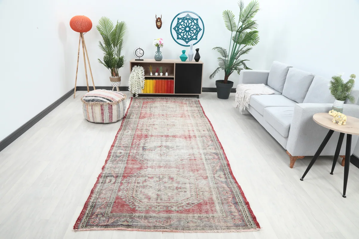 Faded Red Geometric Anatolian Runner in a living room setting, angled view