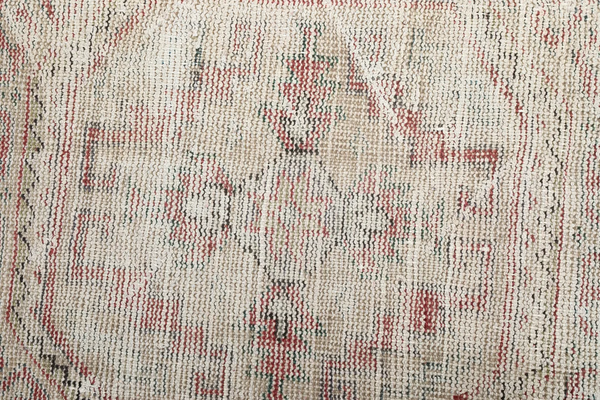 Close-up of the Faded Red Geometric Anatolian Runner's low pile and visible wool texture