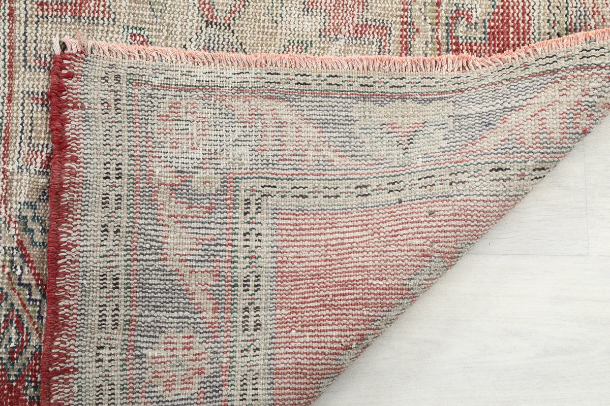 Underside view of the Faded Red Geometric Anatolian Runner, revealing the hand-knotted structure