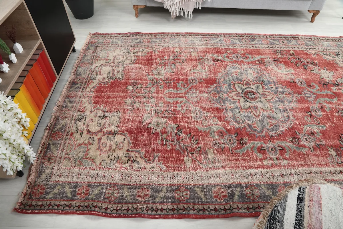 Another room view of the red and blue vintage rug, showing its placement relative to furniture