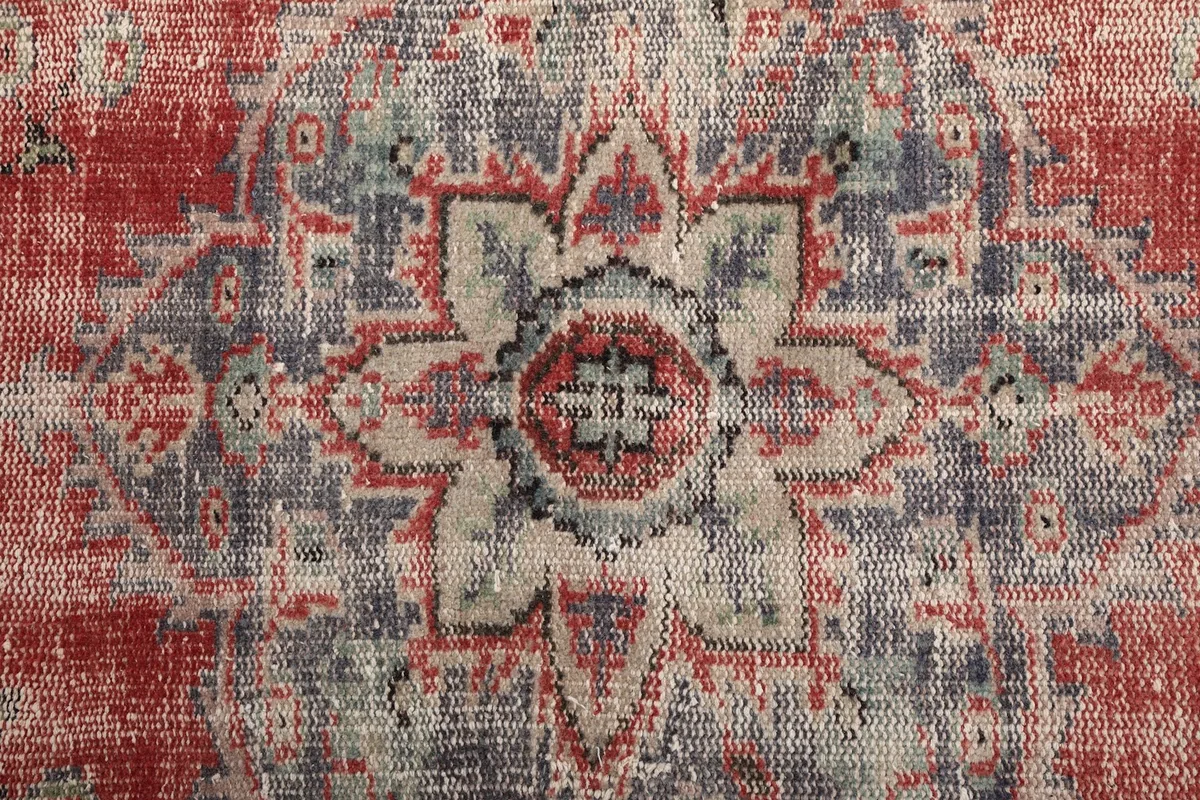 Detailed overhead view of the central medallion, highlighting the intricate blue, red, and beige motifs