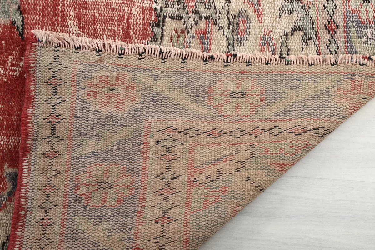 Close-up of the rug's backside, revealing the hand-knotted cotton foundation and weave