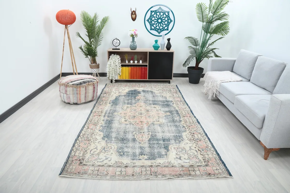 Vintage navy and rose area rug placed in a modern living room setting