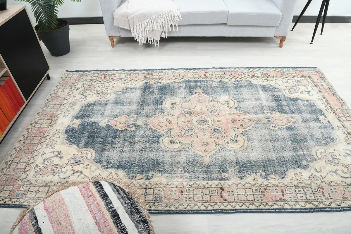 Full view of the vintage Anatolian rug in a room, showing its placement