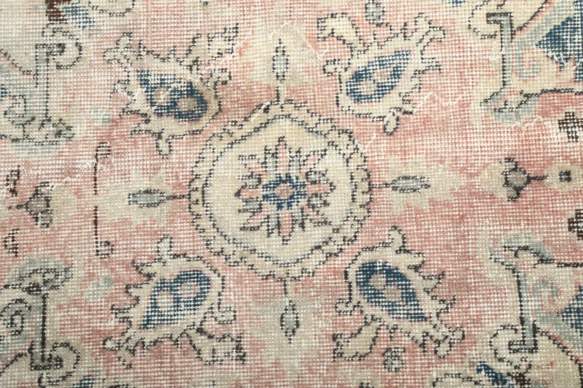 Close-up of the central rose medallion with intricate cream and navy motifs